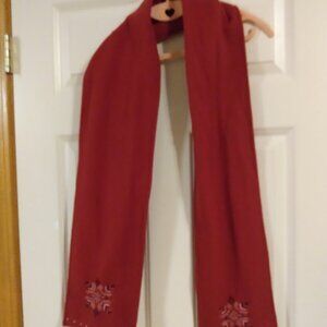 Red scarf with needle point design. Measures approx. 8"x70".